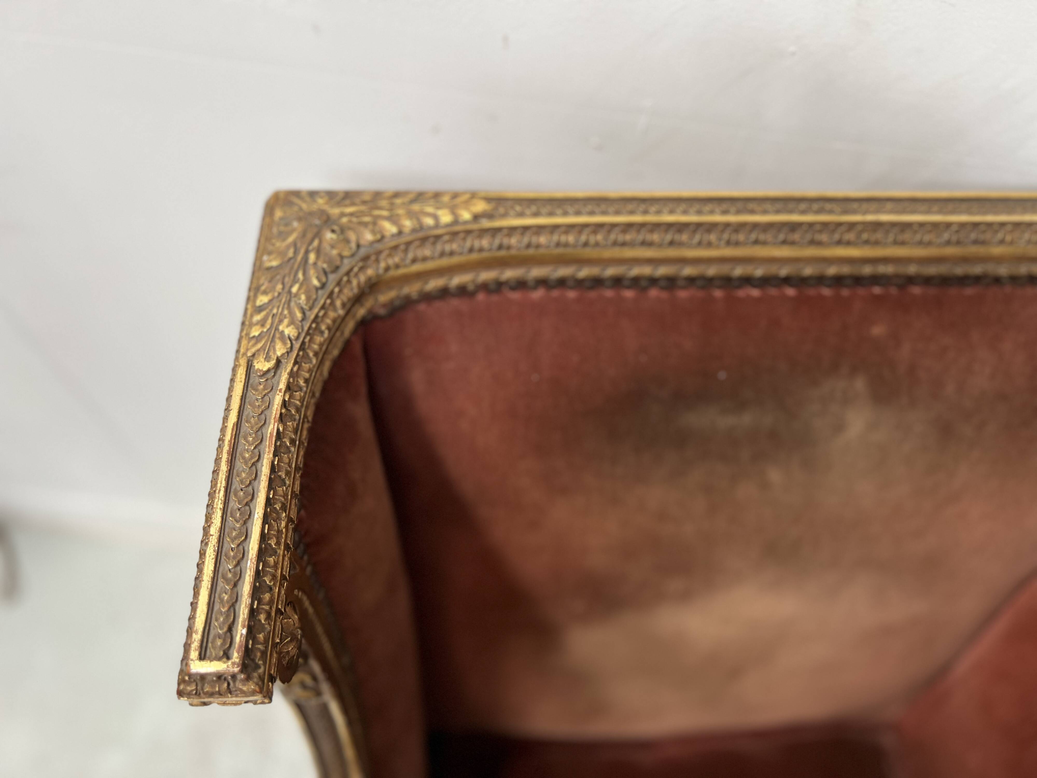 Two Louis XVI style wing chairs in gilded wood, 20th century