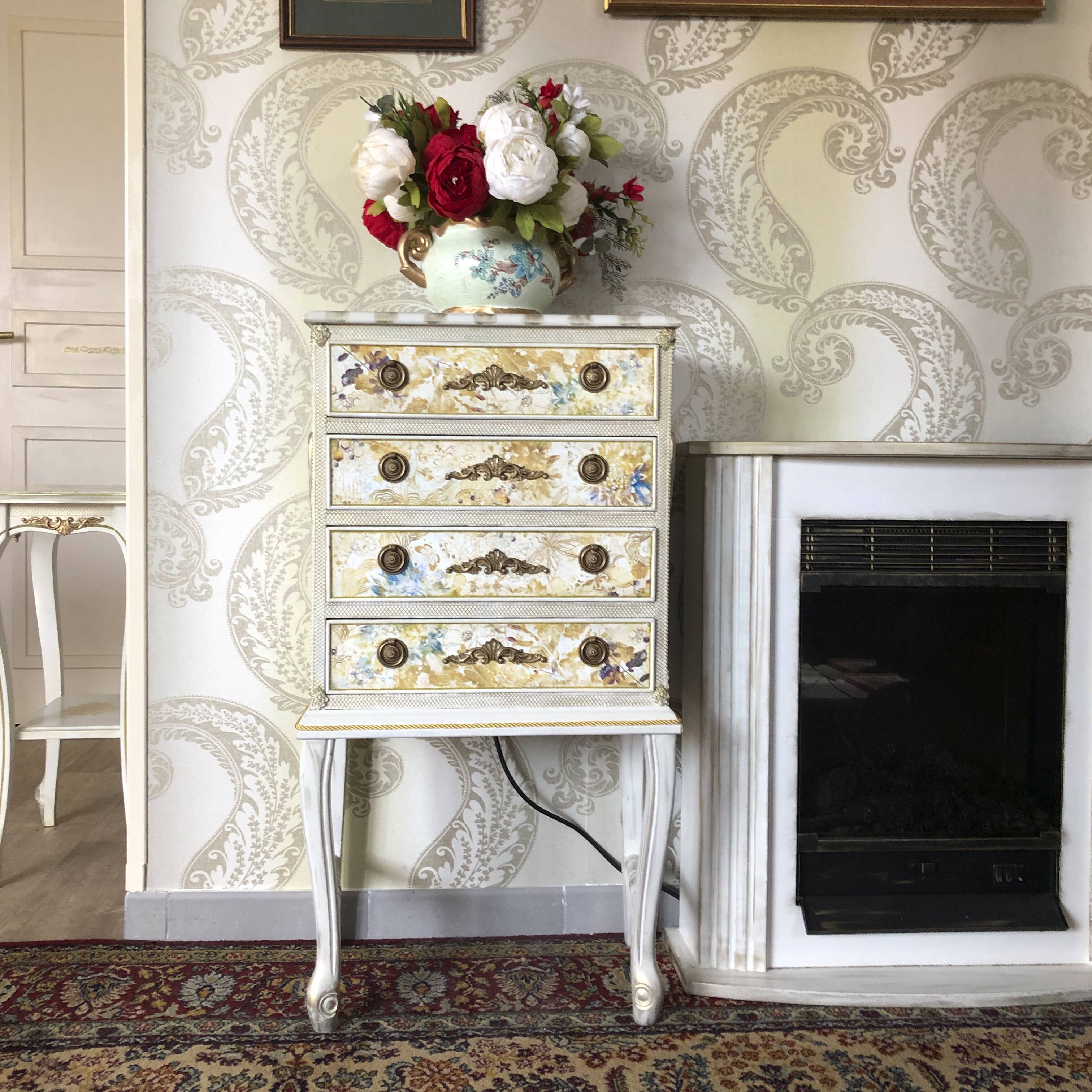 Vintage commode refurbished with 4 drawers in classic style with floral decor.