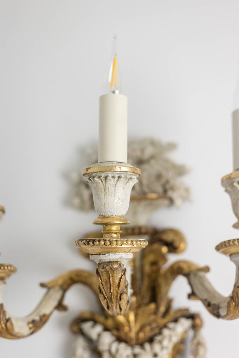 Pair of Louis XVI style wall lights in gilded and lacquered wood. Circa 1900.