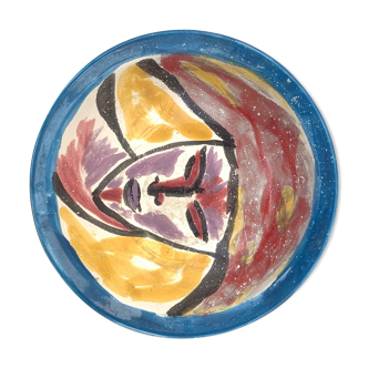 Hand-painted plate decorated with a colorful face 60s