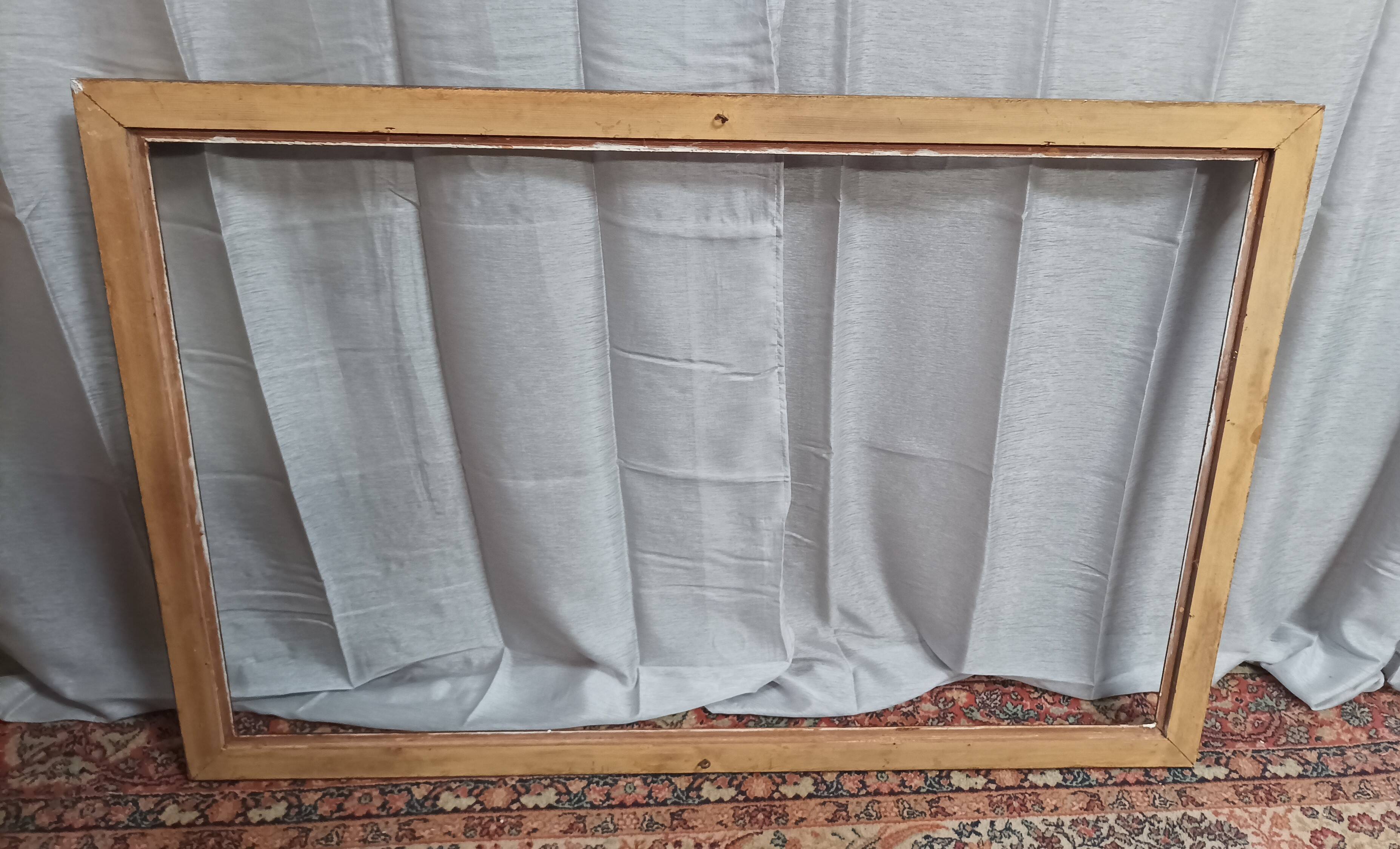 Old frame in wood and gilded stucco