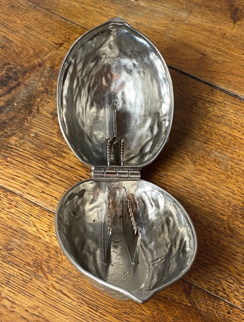 Nutcracker, shaped like a large nut, silver-plated metal