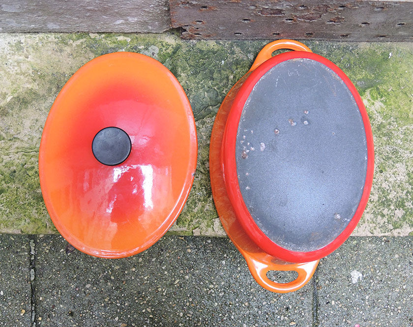 Old oval casserole in orange enamelled cast iron