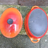 Old oval casserole in orange enamelled cast iron