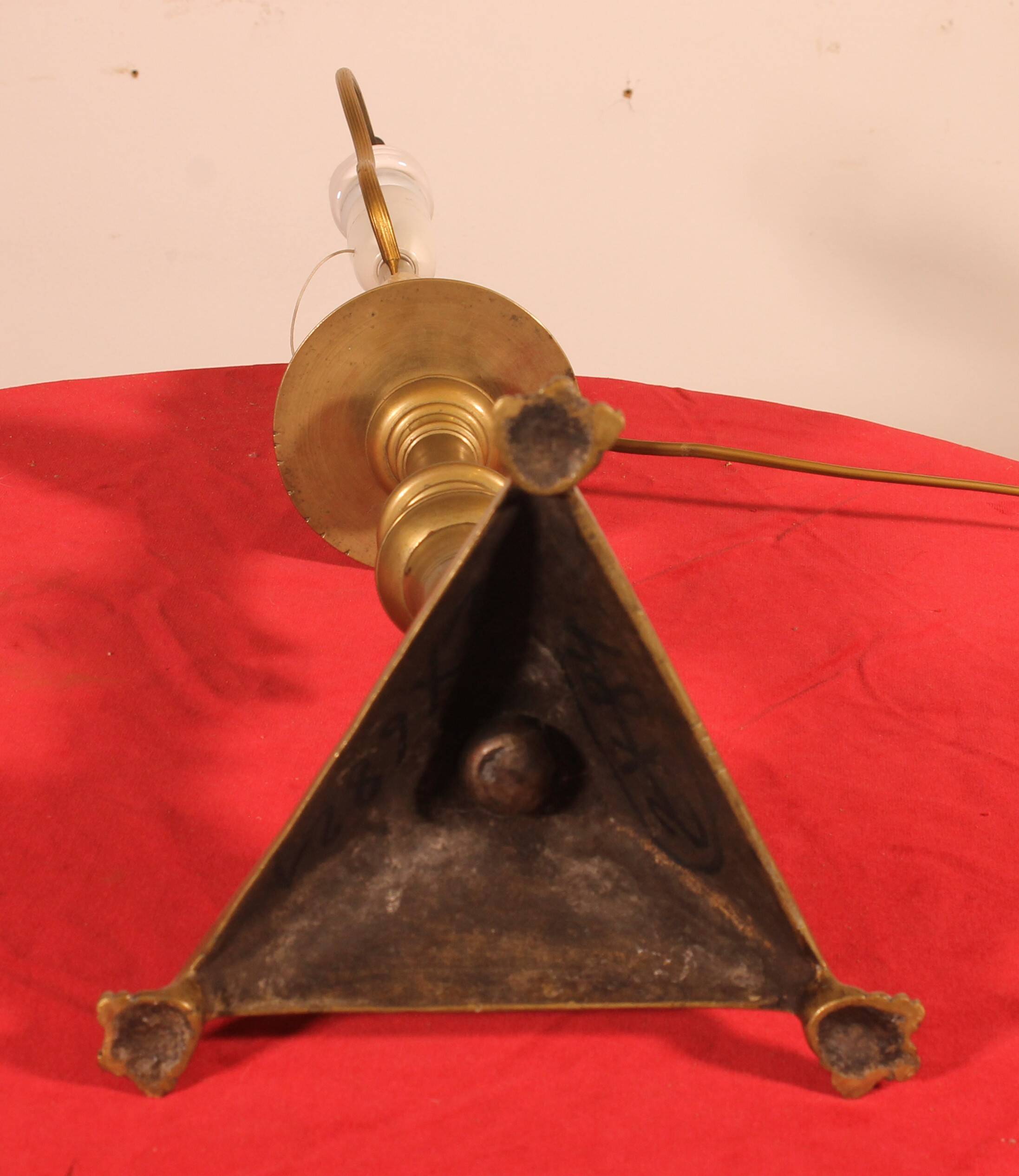 bronze candlestick from the 17th century converted into a lamp with its lampshade