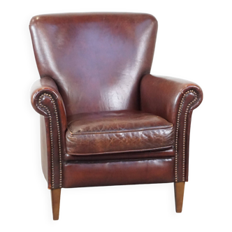 Sheepskin armchair correctly finished with decorative nails and in good condition