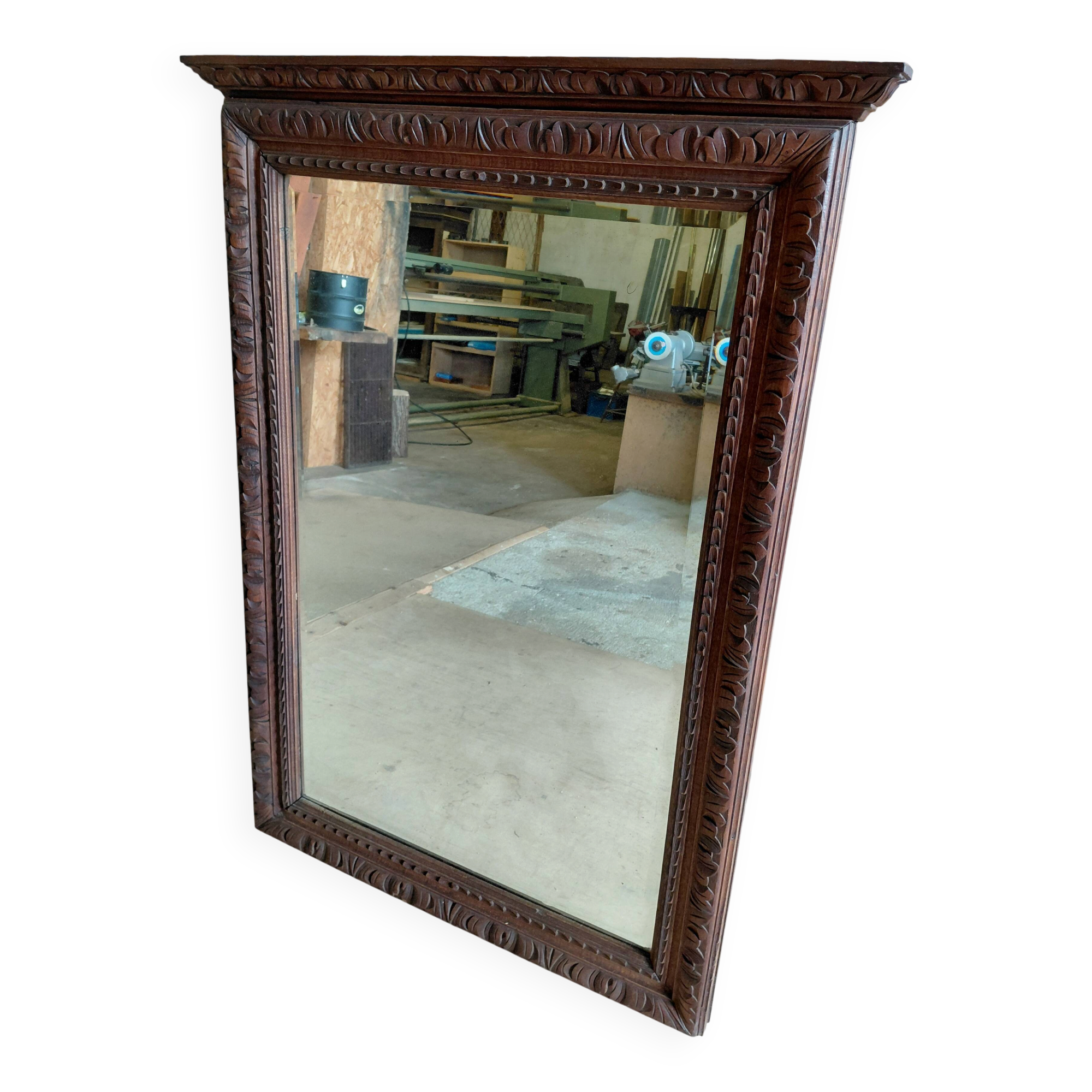 Large bevelled mirror with a carved wooden frame