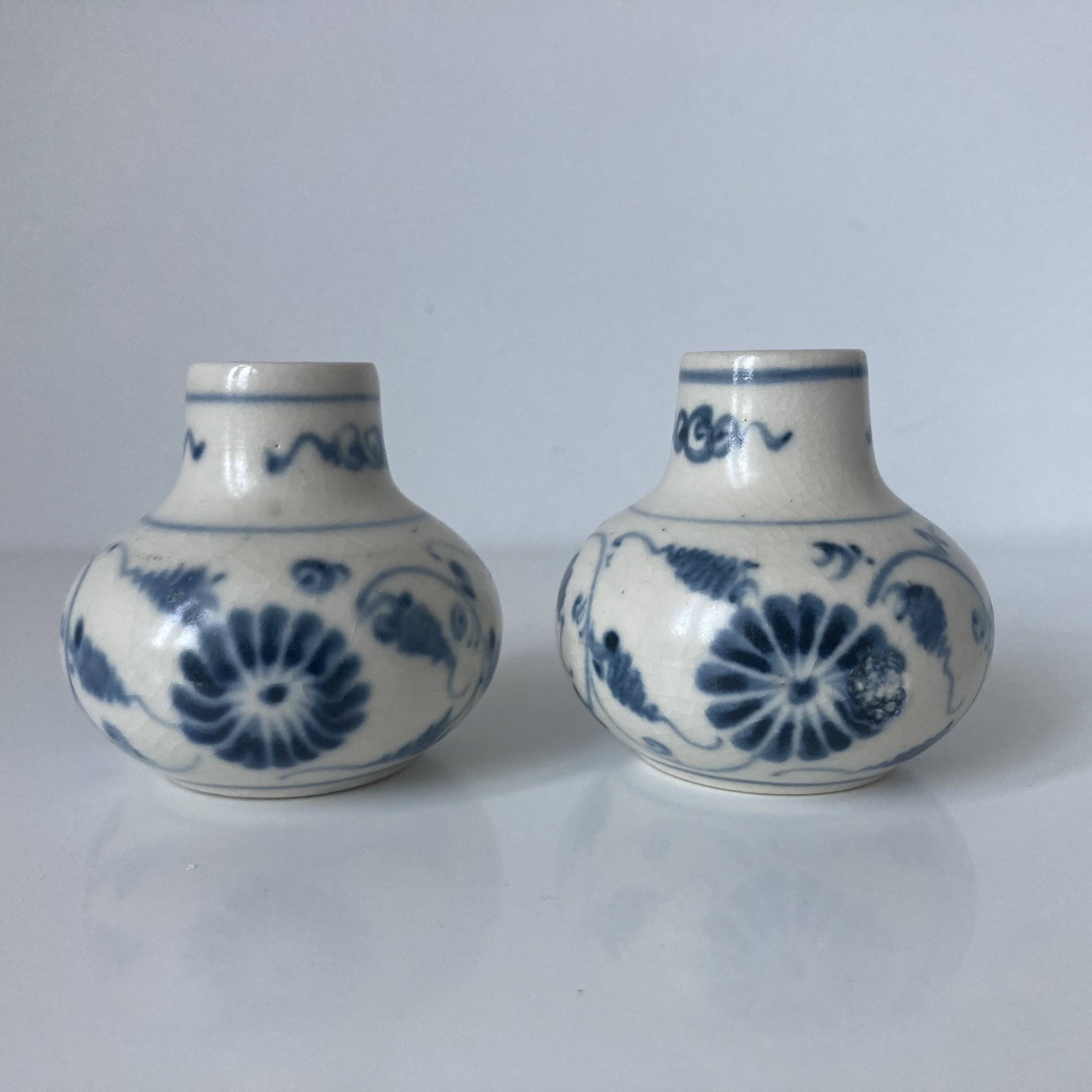 Pair of miniature blue and white Vietnamese ceramic vases with floral decoration.