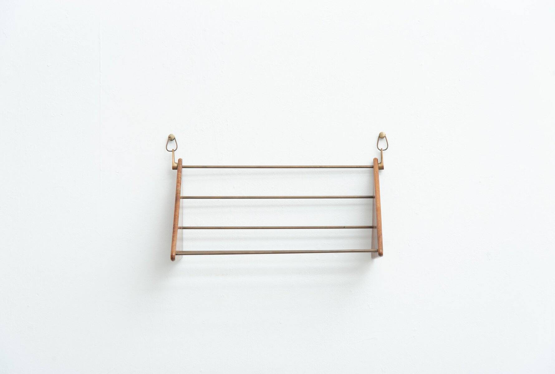 Wall-mounted walnut bookshelf by Carl Auböck, 1950s