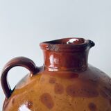 Old pitcher in glazed terracotta