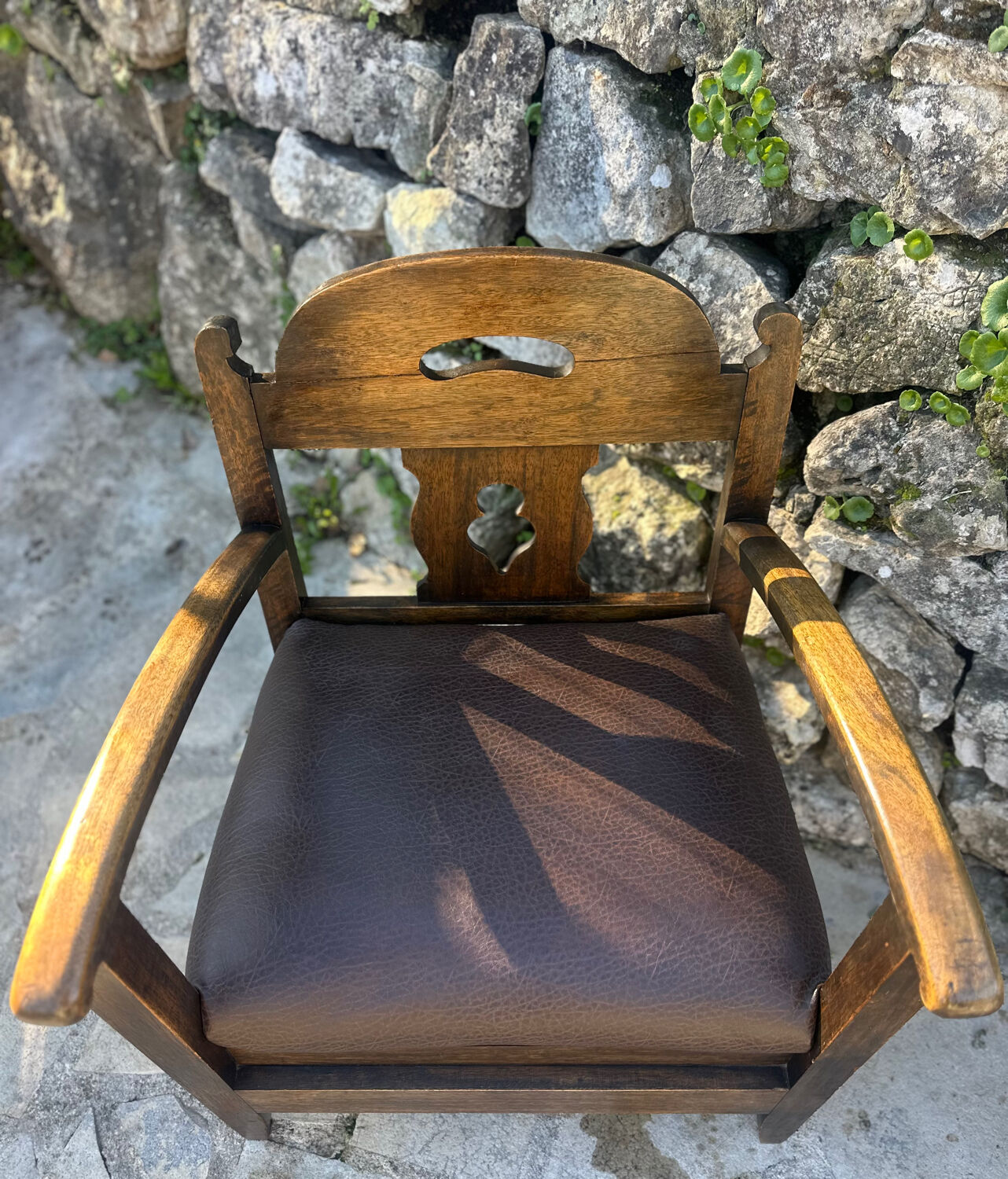 Pair of armchairs in stained wood and leather, 20th century