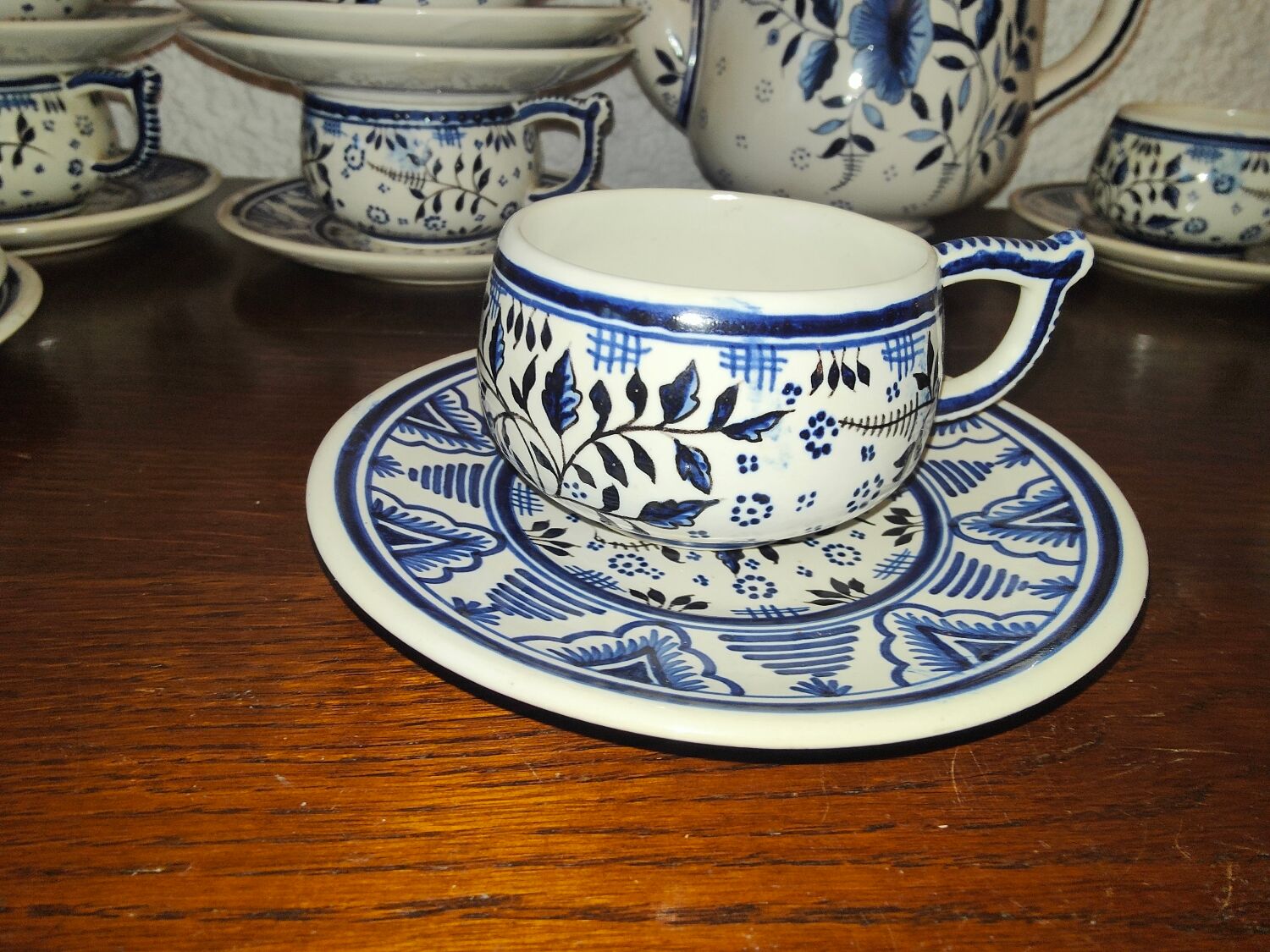 Henriot Quimper earthenware coffee set with floral decoration and elegant blue