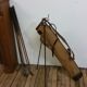 Old golf bag with 5 golf clubs