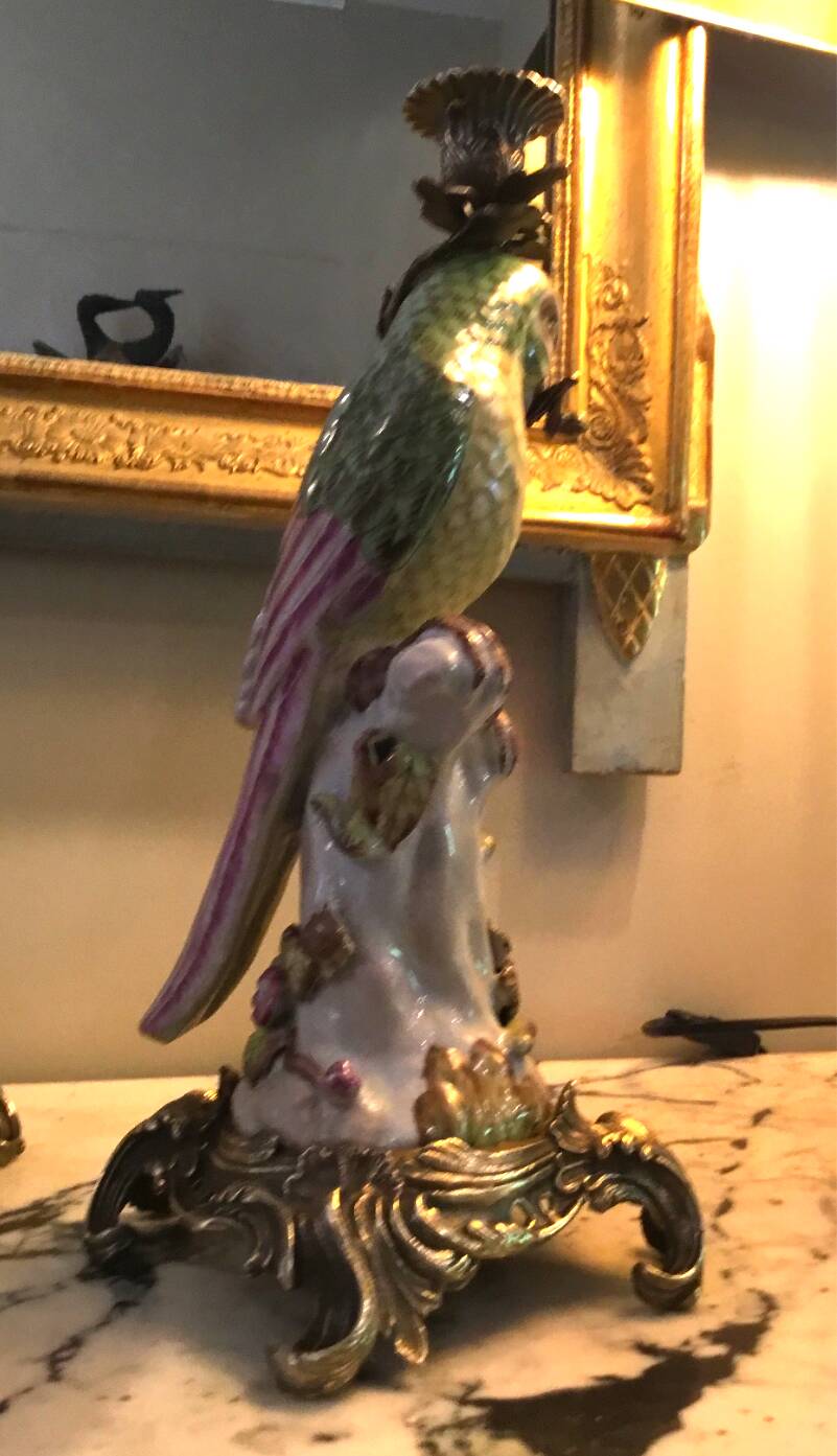 Pair of porcelain candlesticks with parrots and bronze mounts.