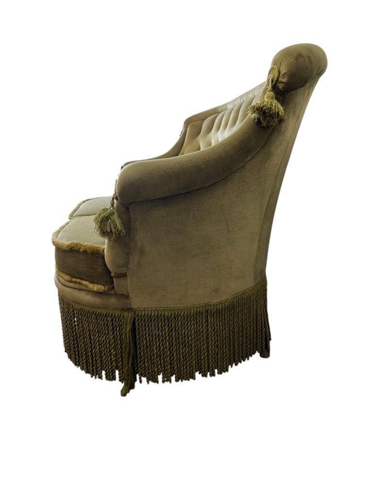 Vintage green two-seater sofa with fringes