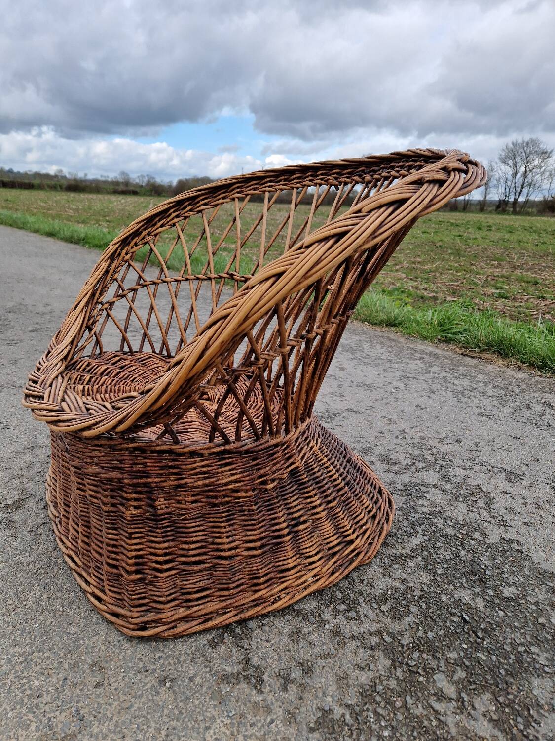 Old throne basket armchair in woven wicker