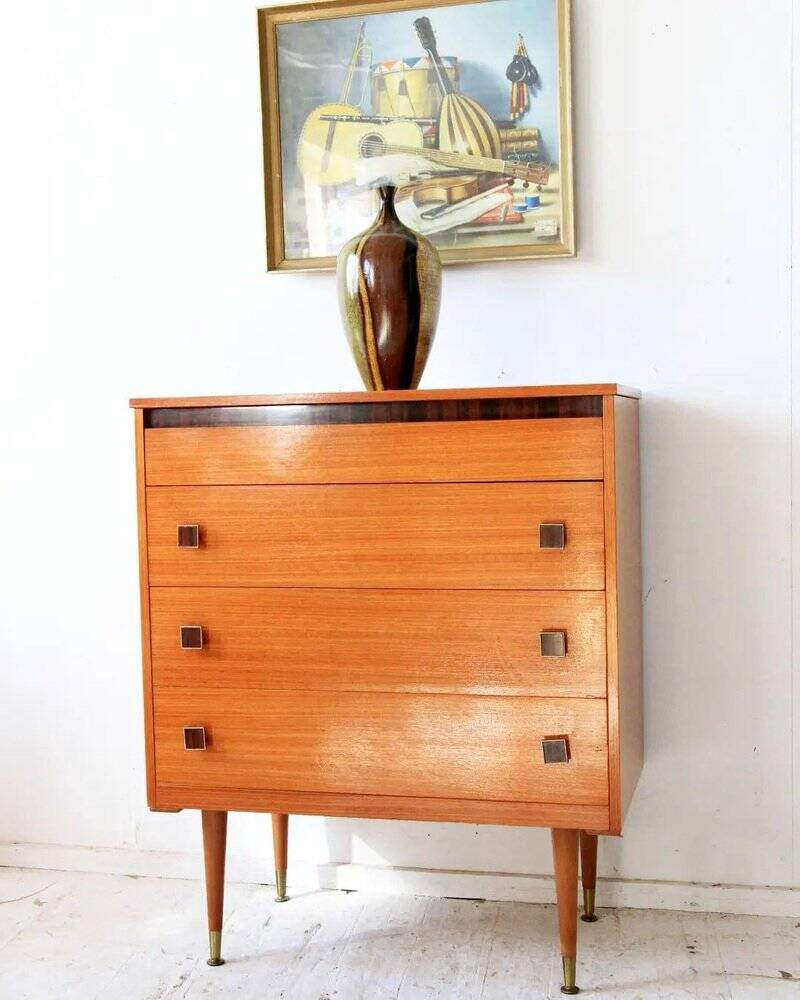 Mid-century brown teak chest of drawers with three drawers, tapered legs from the 1960s.