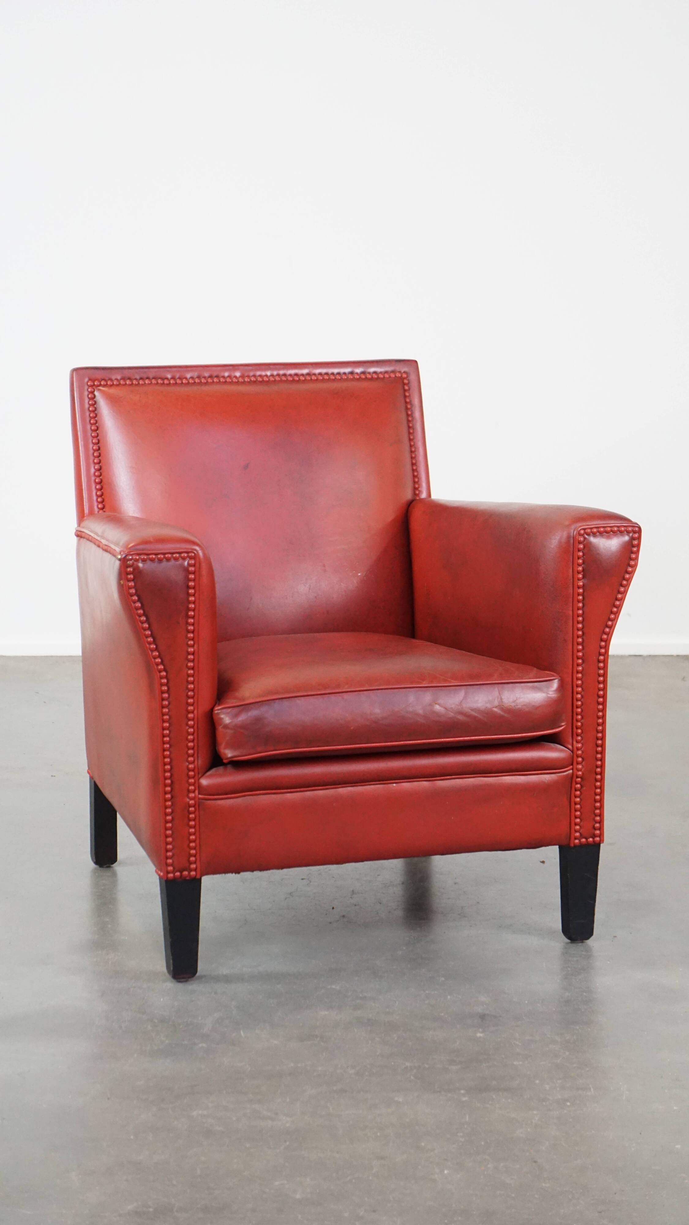 Red-painted armchair made of sheepskin leather