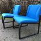 Electric blue fabric designer armchairs with black lacquered metal legs from the 80s.