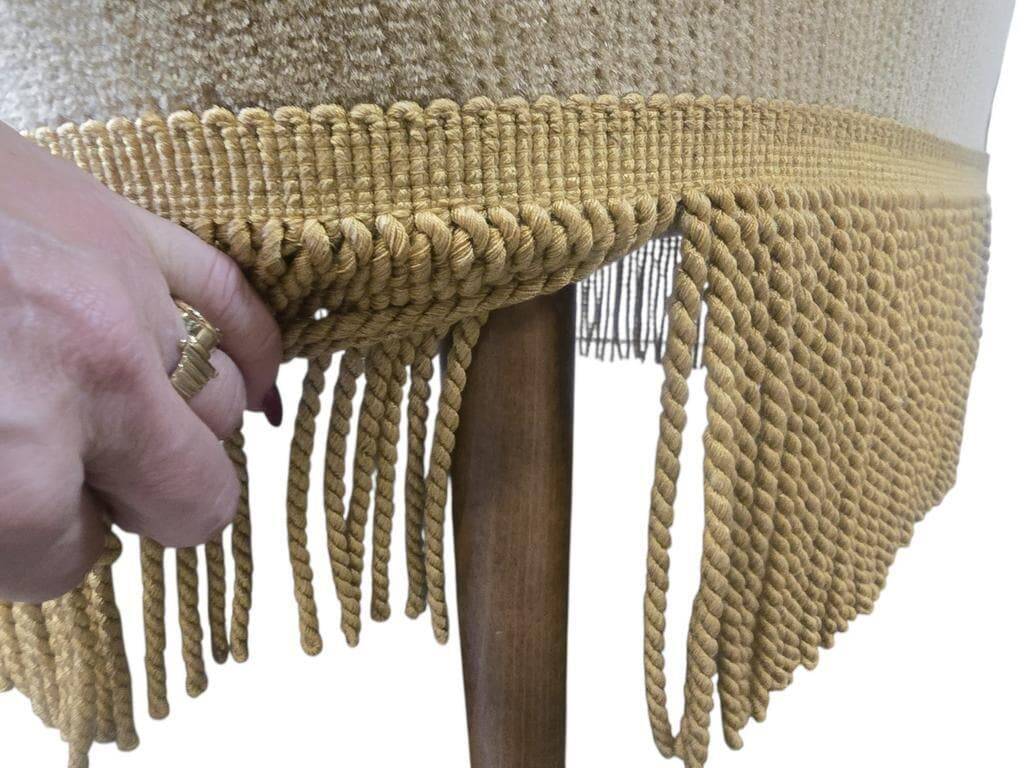 Set of 2 vintage 'gold' armchairs with fringes.