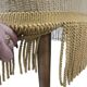 Set of 2 vintage 'gold' armchairs with fringes.