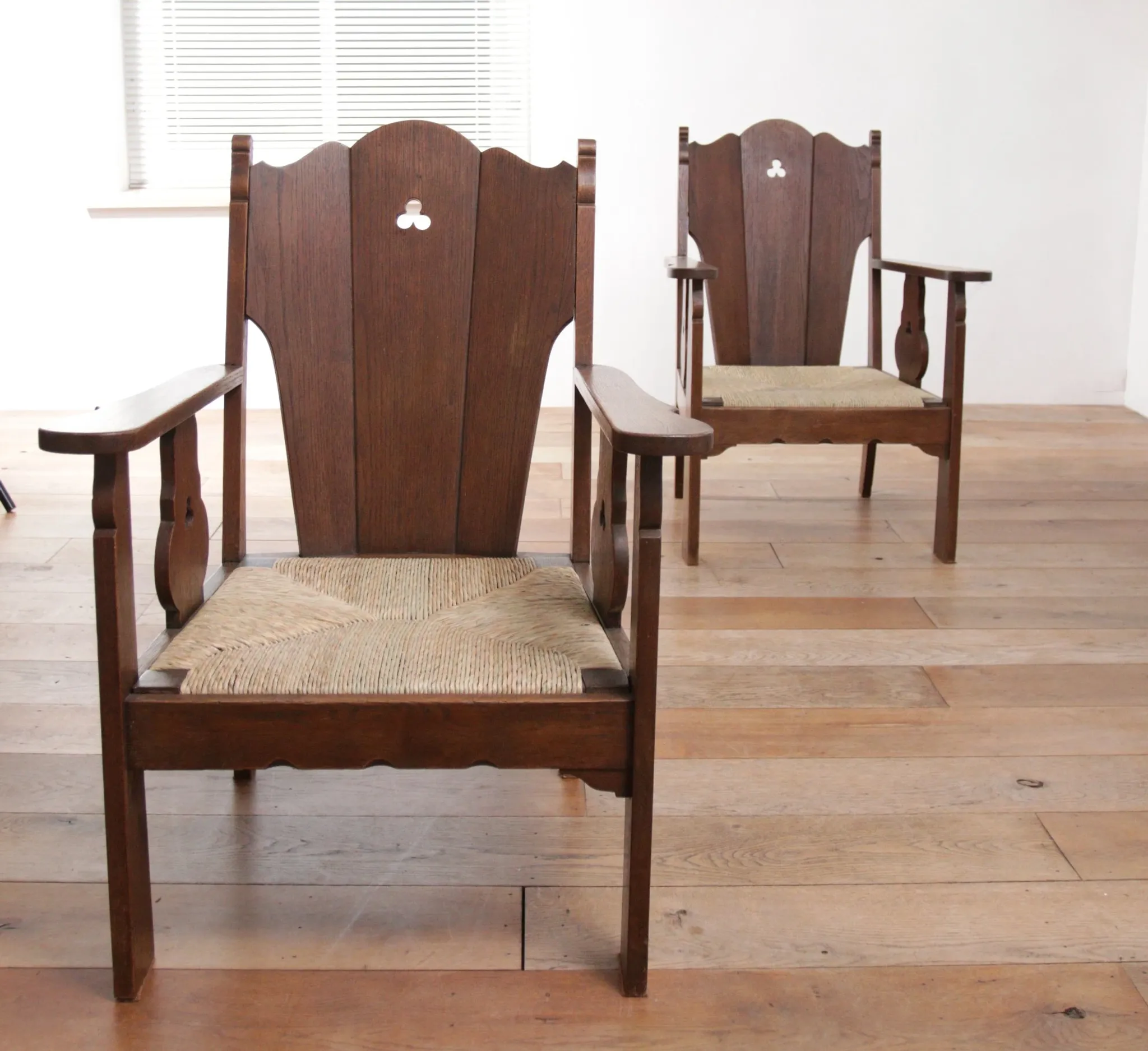Pair of low Brutalist oak lounge chairs with new rush seats – circa 1935