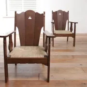 Pair of low Brutalist oak lounge chairs with new rush seats – circa 1935