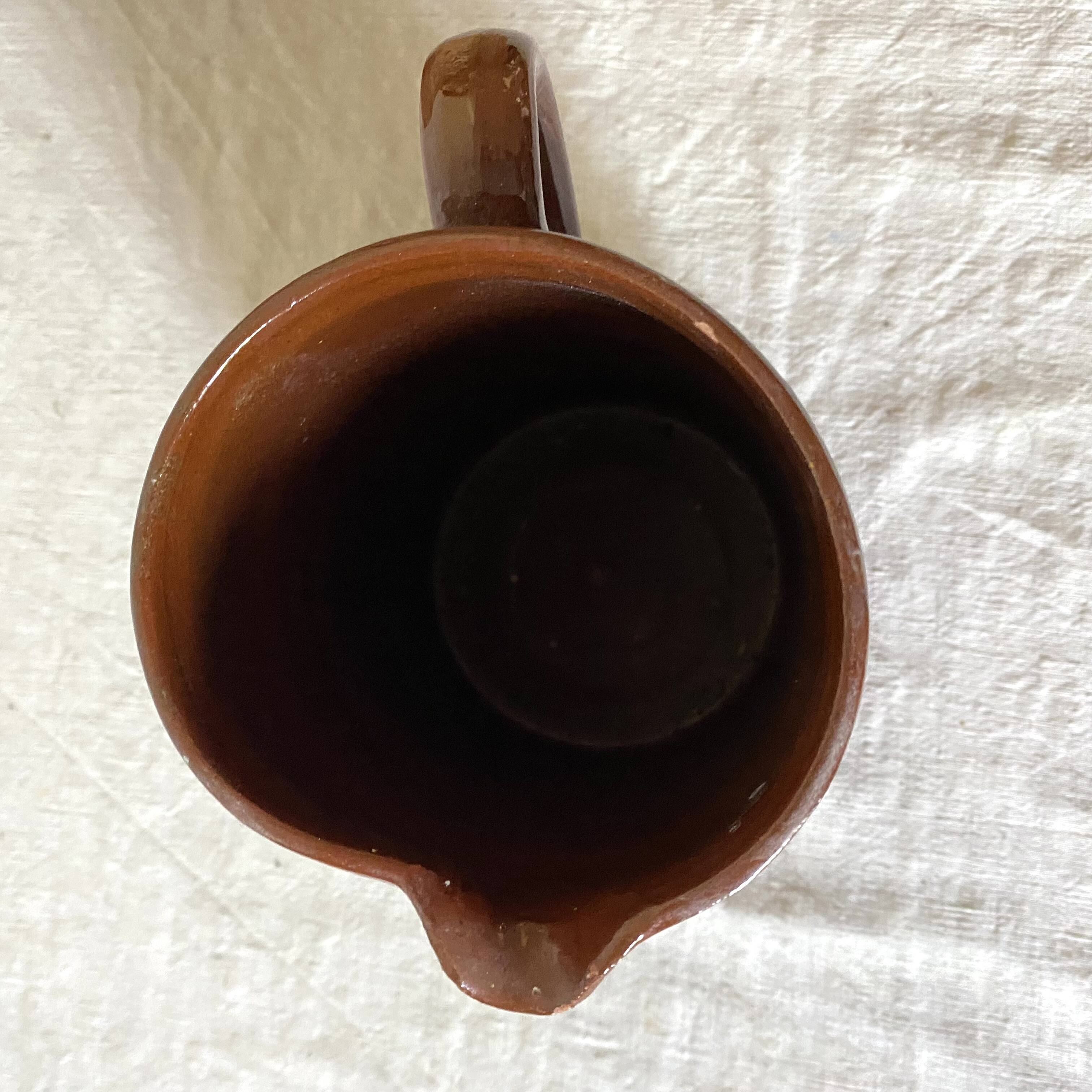 Terracotta pitcher with hand-painted bird decor