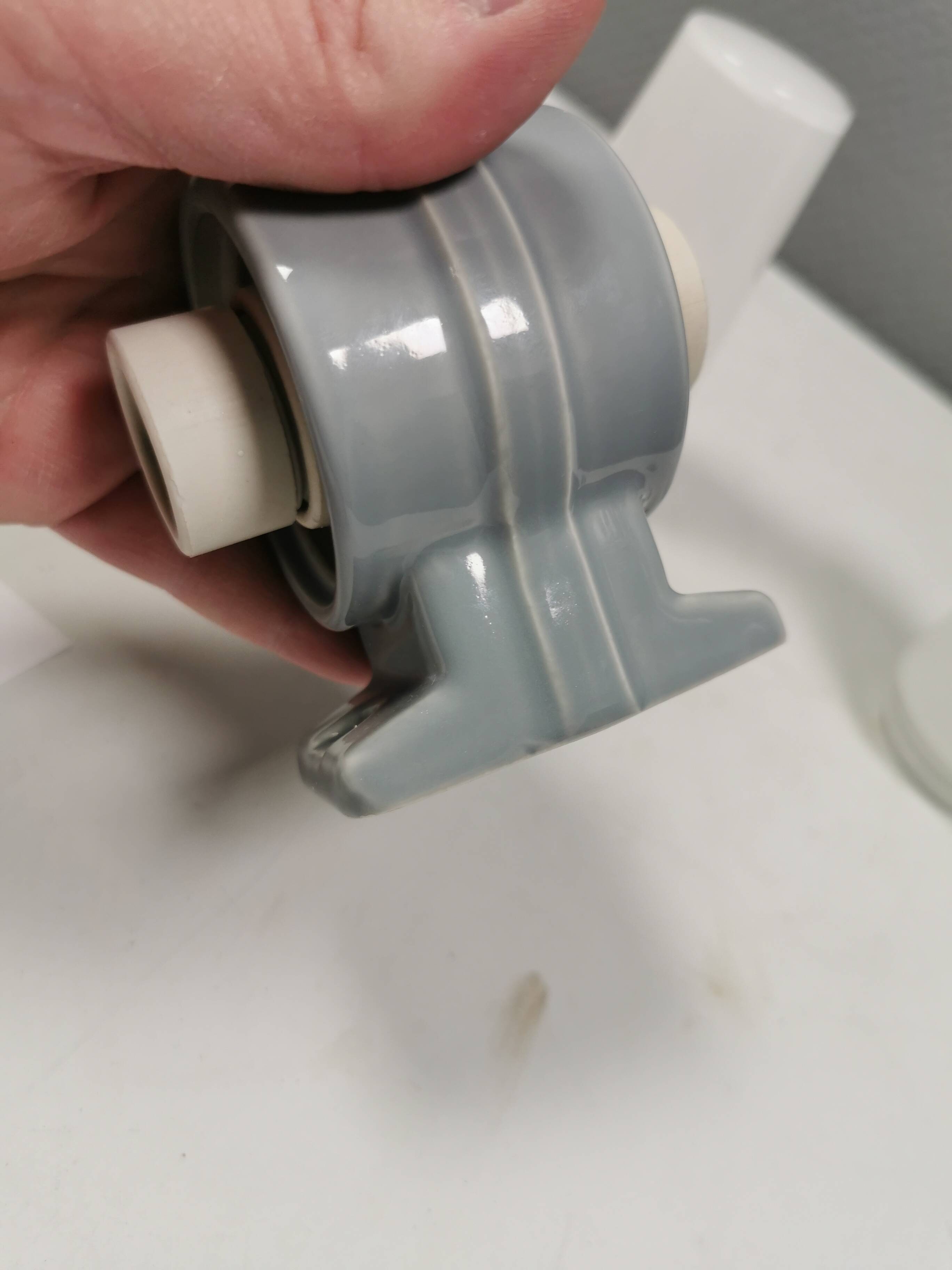 Bathroom lamp with light gray ceramic base,  and milky white opal glass.