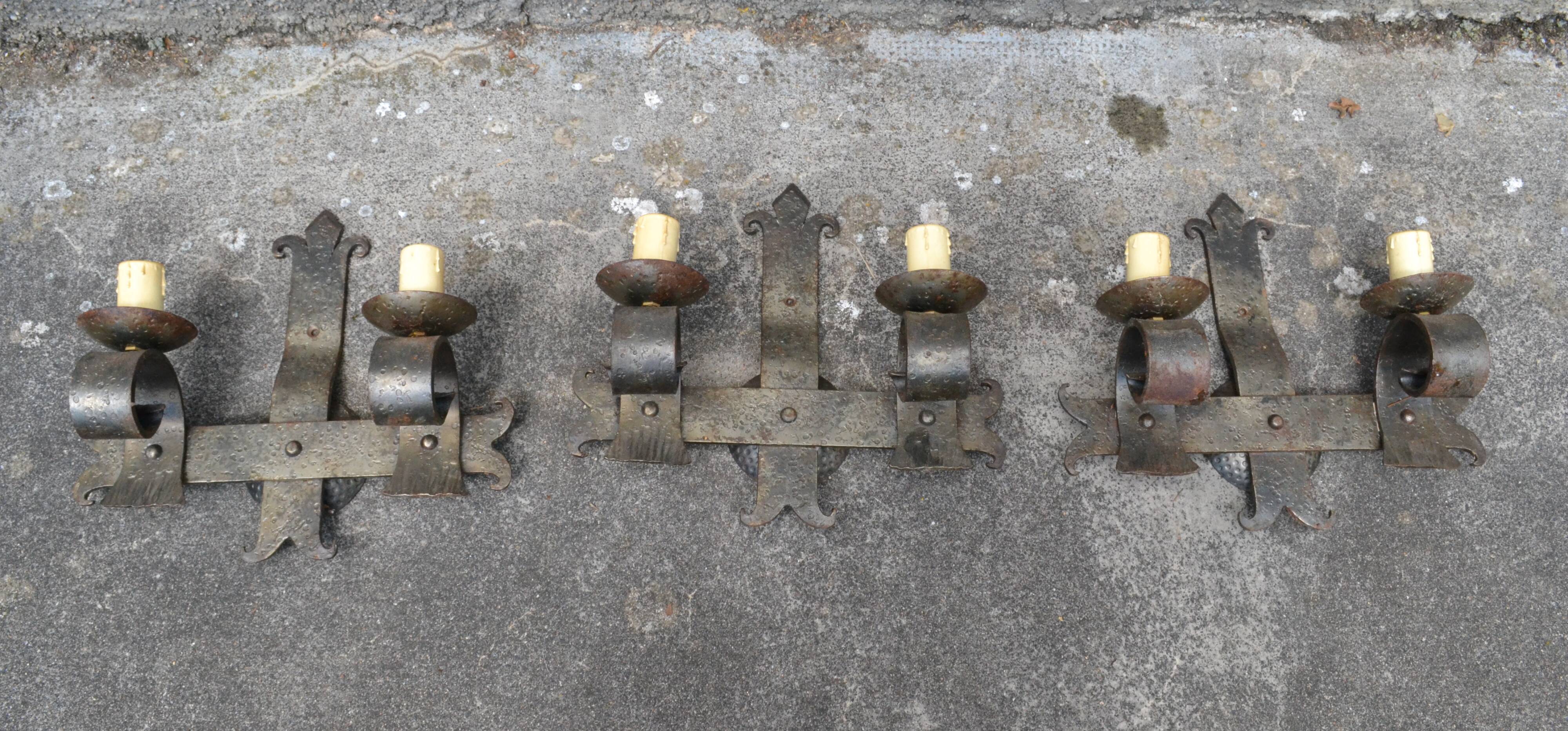 Three vintage hammered wrought iron sconces