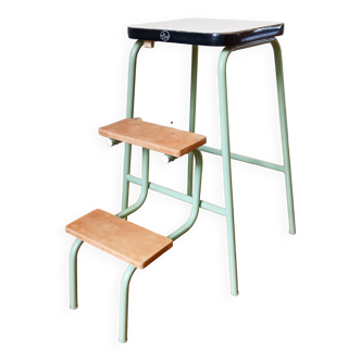 Step stool in green metal, wood and white Formica.