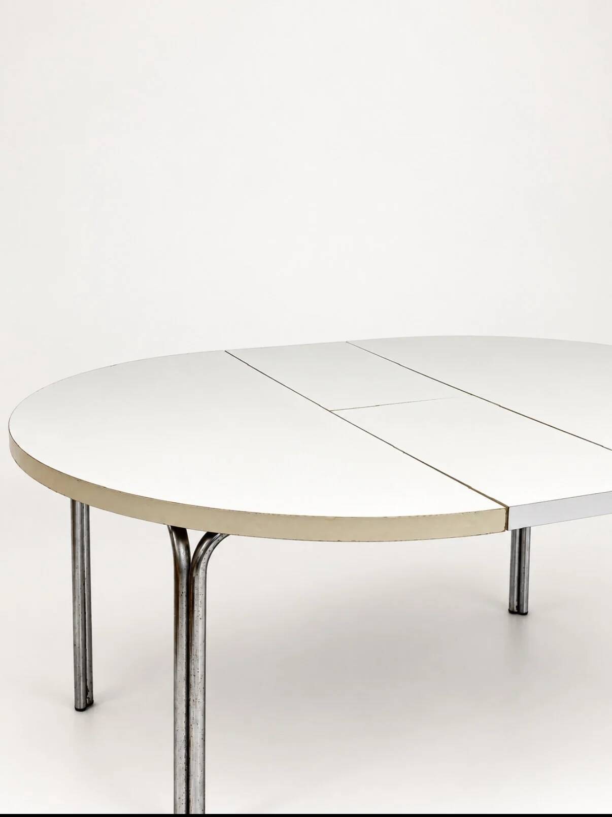 Vintage round extendable dining table, white laminate on chrome legs.