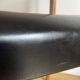 Vintage chair in wood and black leatherette