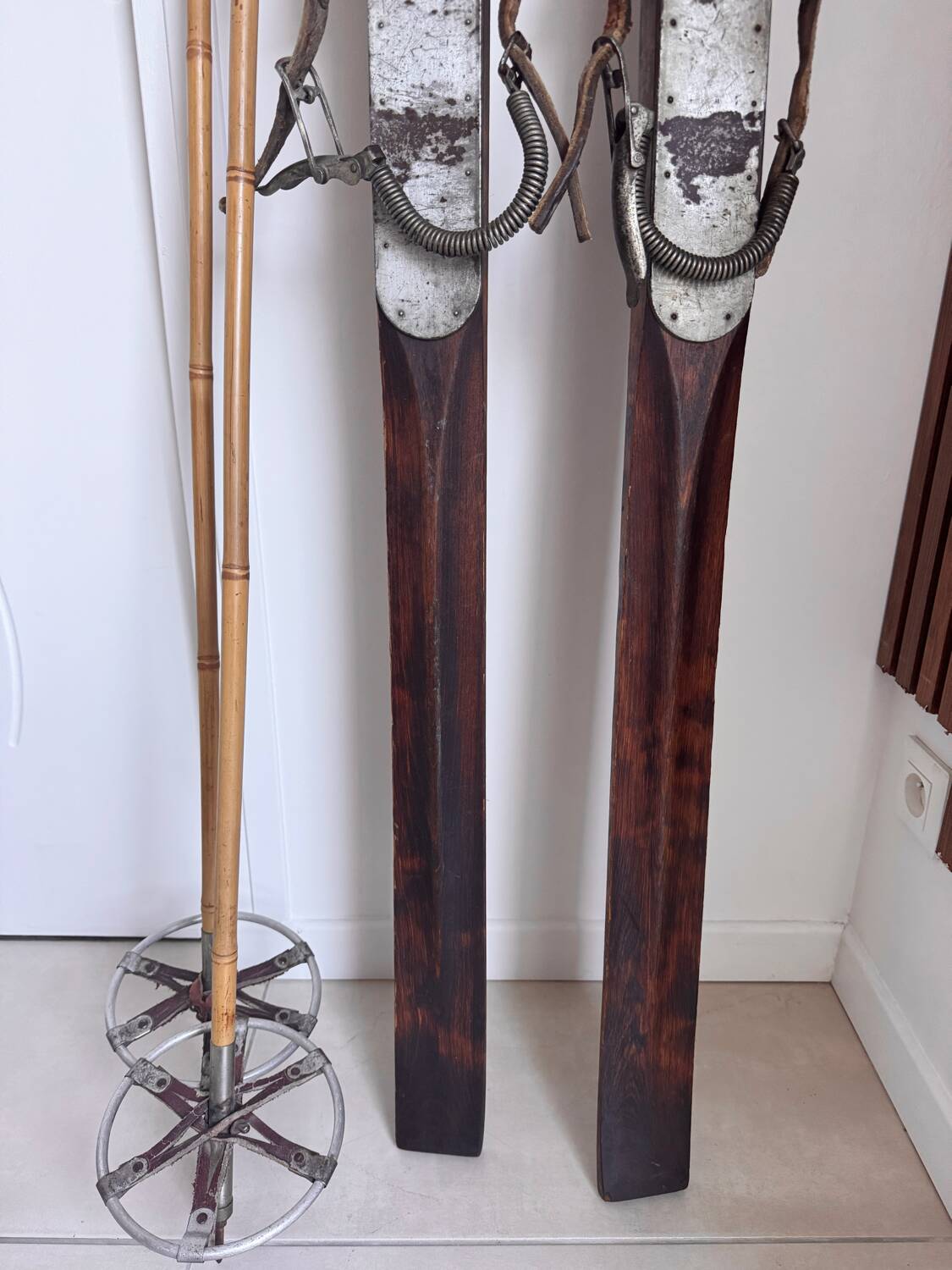 Antique wooden skis with vintage poles