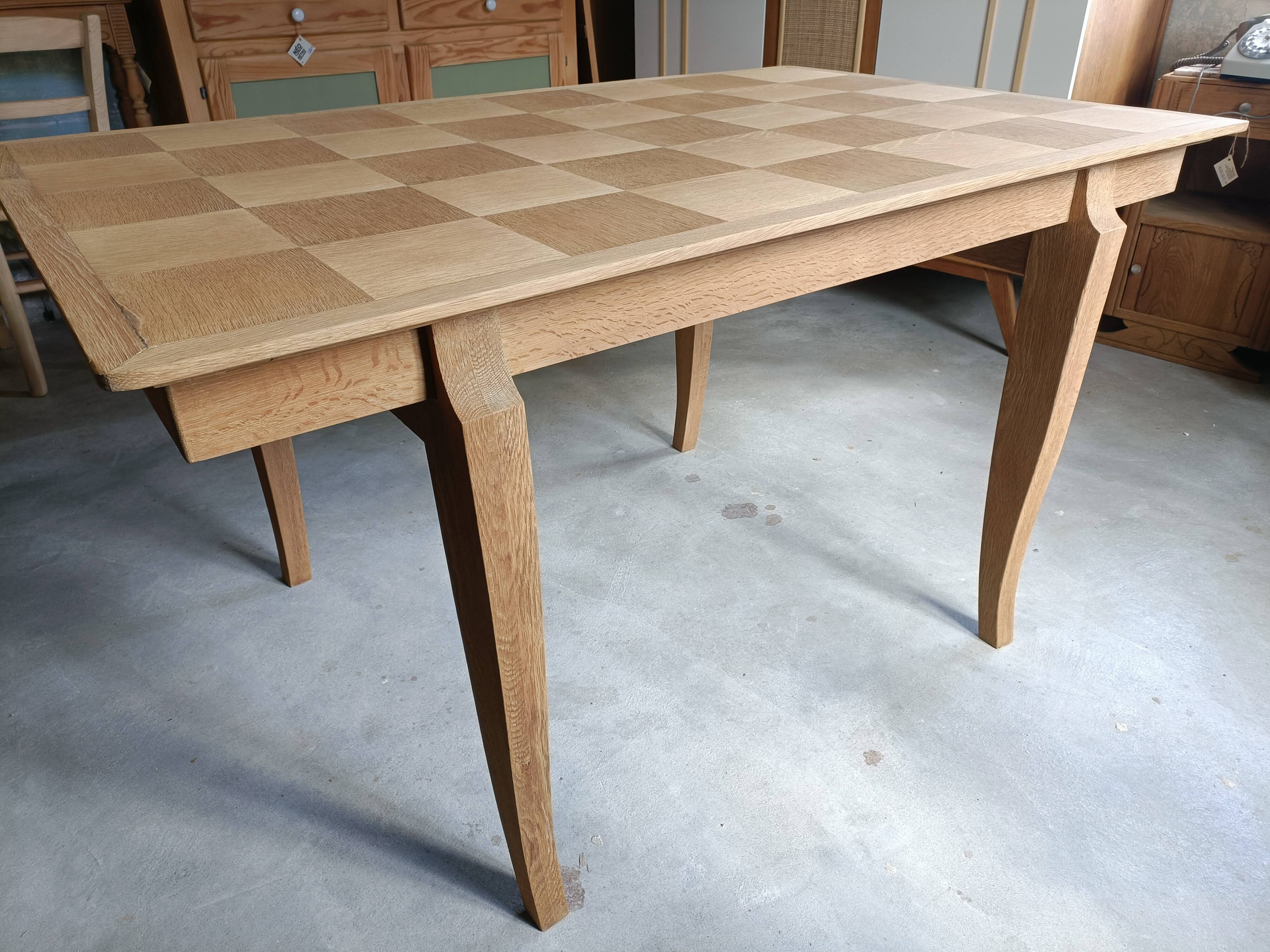 Oak dining table with a checkerboard top and extensions.