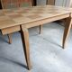 Oak dining table with a checkerboard top and extensions.