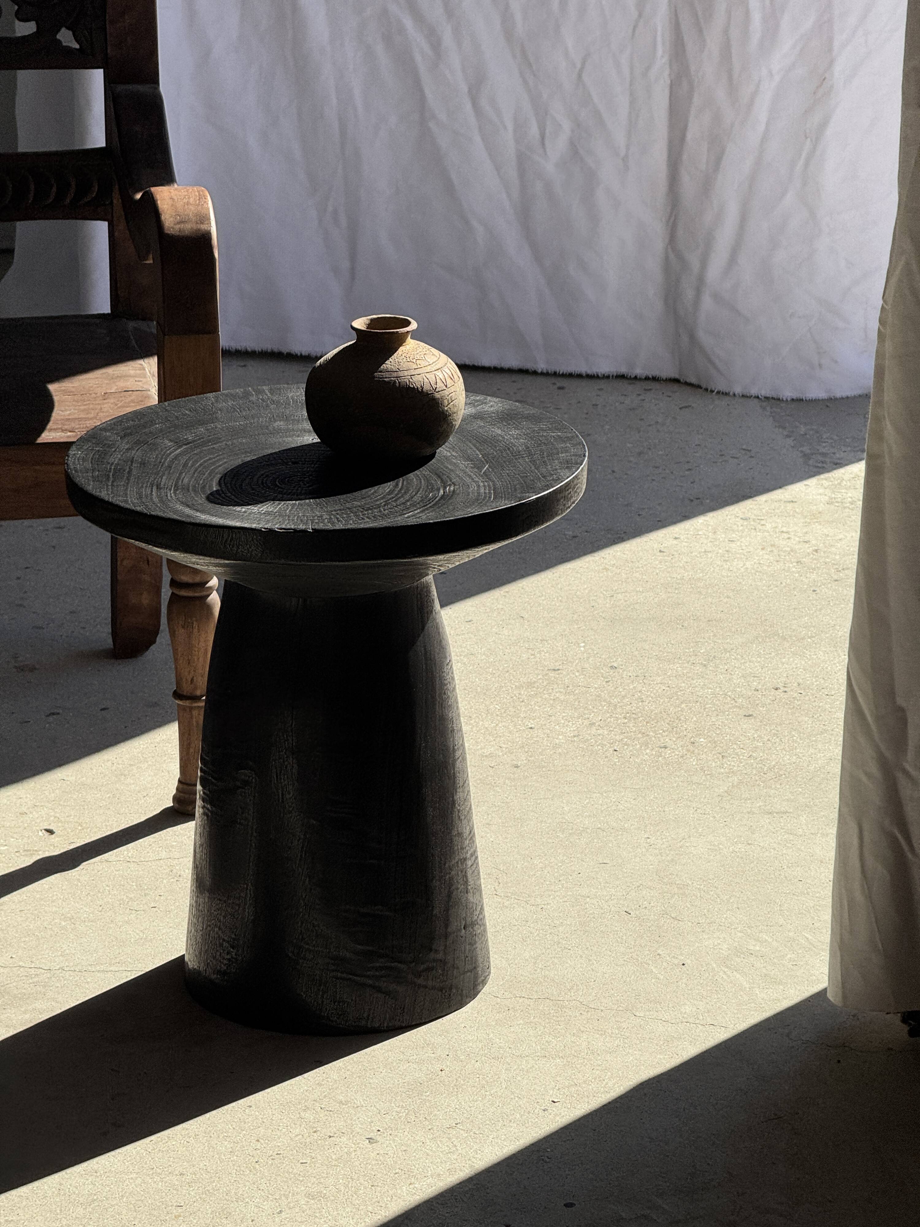 Black solid mango side table (monoxyle) with conical legs