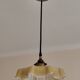 Electrified suspension with a frosted opaque glass disc shade.