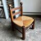 Low brutalist chair in dark wood and straw n°1