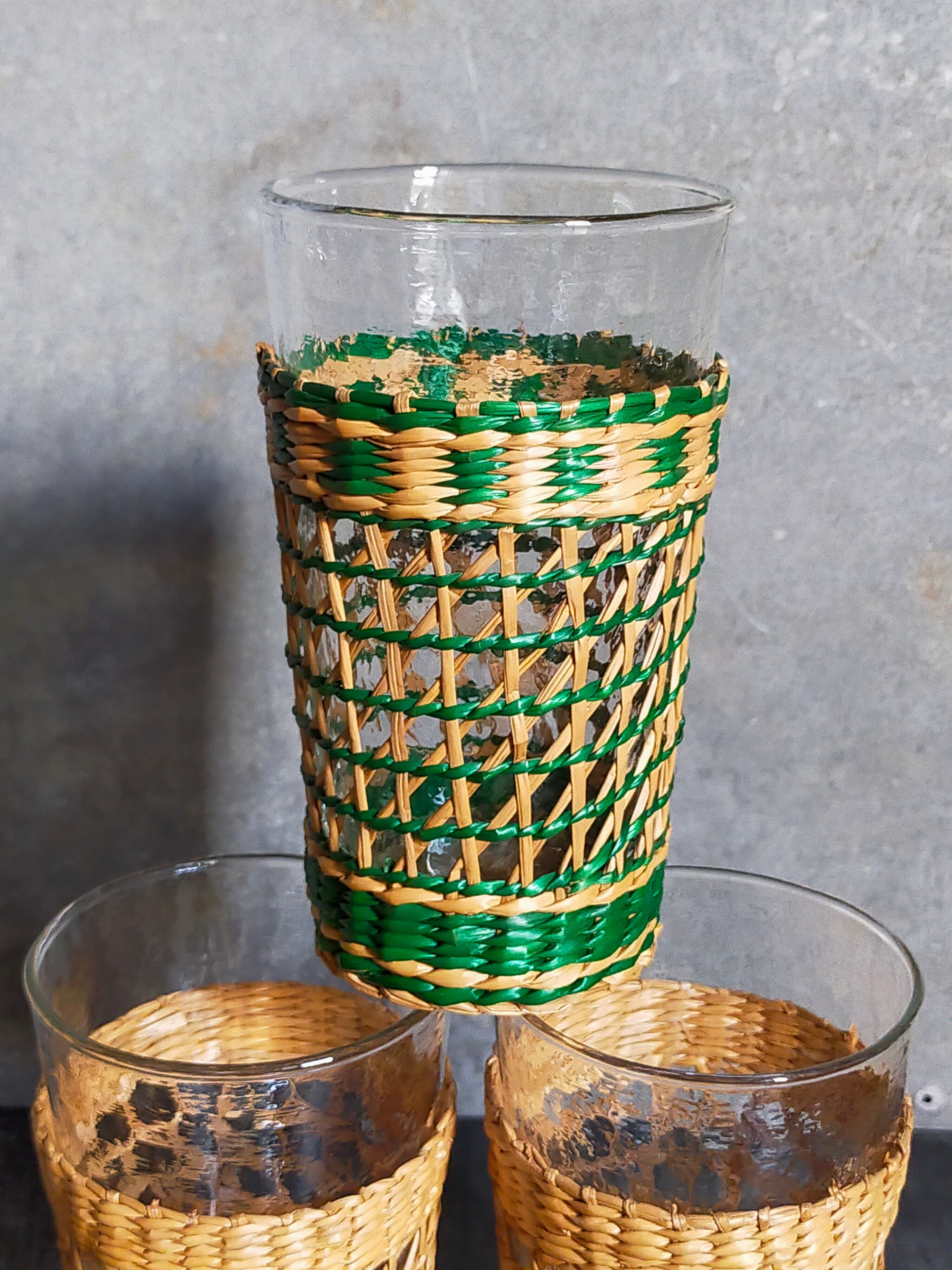 Four long drink glasses in vintage woven rattan cases