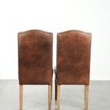 Set of 2 characterful dining chairs of sheepskin leather with a high back