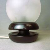Small black wooden table lamp with frosted glass globe
