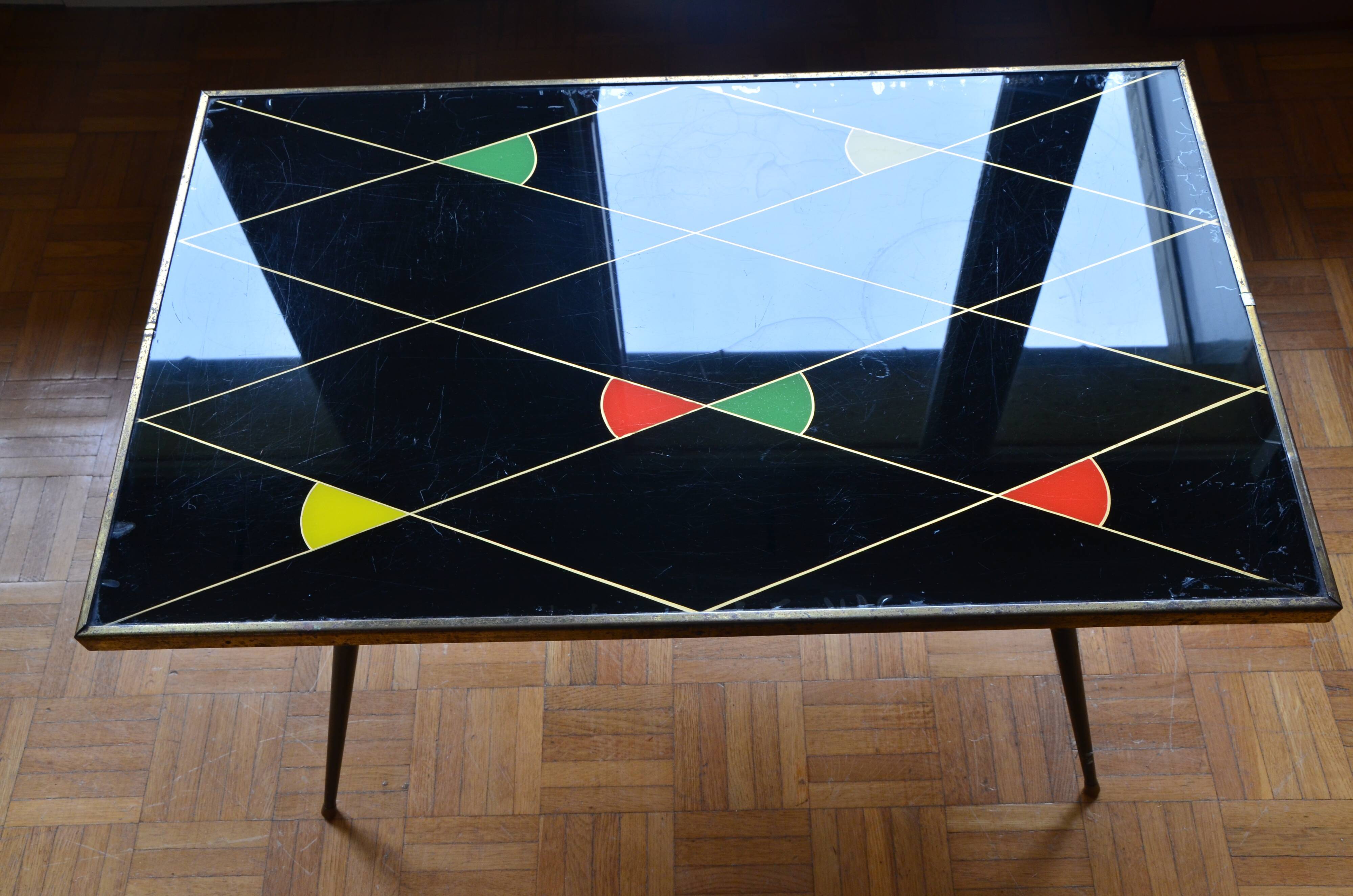 Brass and glass coffee table with compass feet