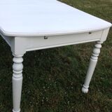 White farmhouse table set and four chairs