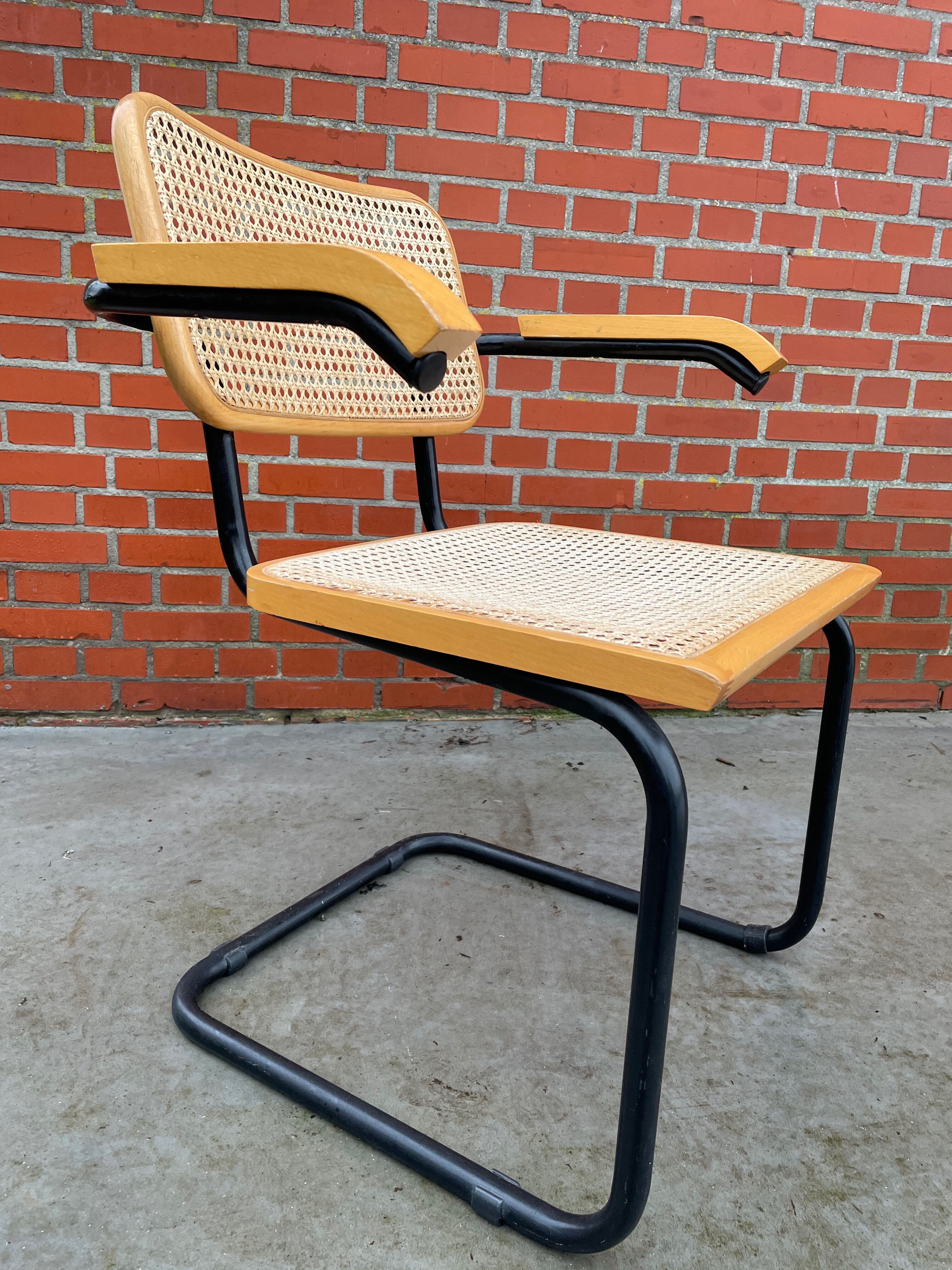 Cesca model chair designed by Marcel Breuer with black-framed armrests