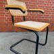 Cesca model chair designed by Marcel Breuer with black-framed armrests