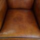 Sheepskin wingback armchair with stitching and black piping