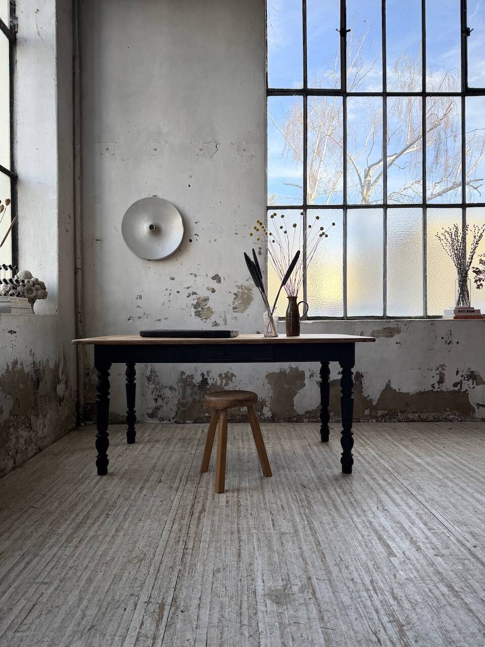 Oak farmhouse table with turned black legs.