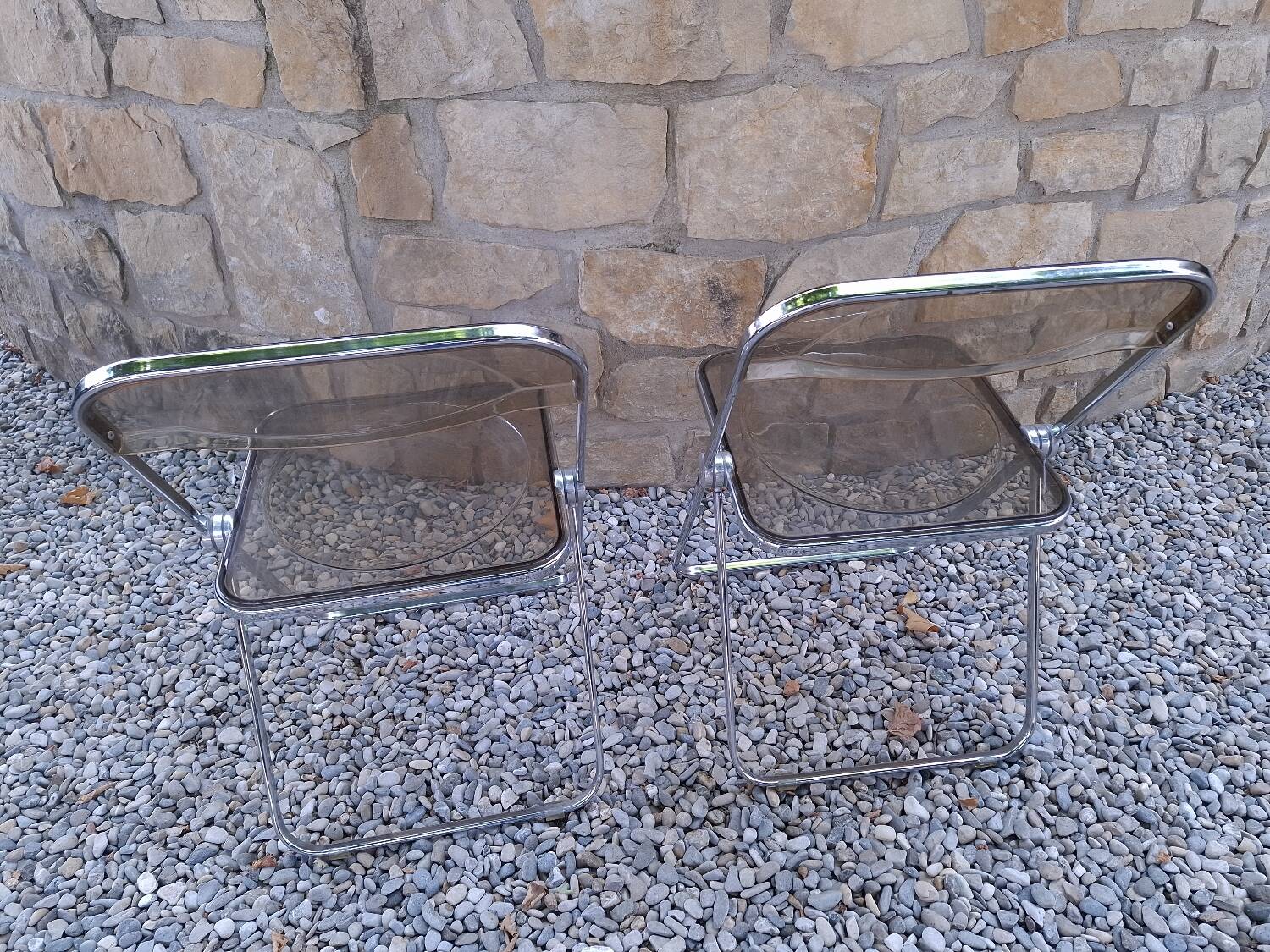 2 folding chairs designed by Giancarlo Piretti for Castelli