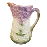 Ancien pichet en barbotine à décor floral mauve